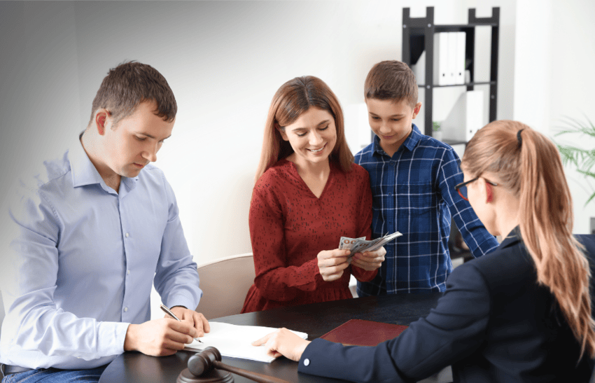 Family discussing child custody relocation with lawyer, father signing documents while mother holds money with child beside her