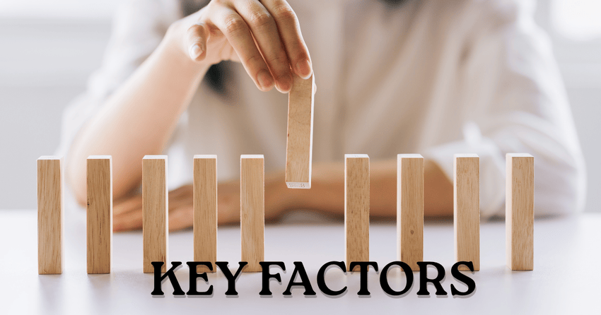 Hand placing wooden block representing key factors in decision making