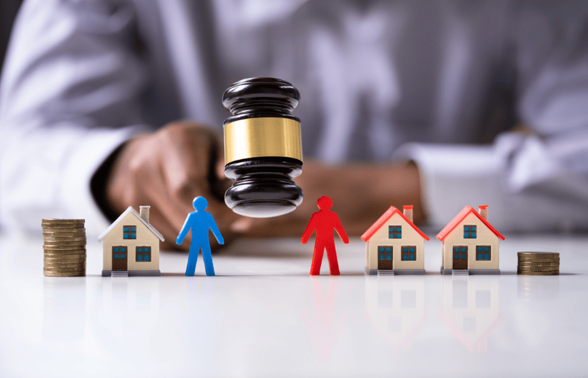 A judge with a gavel, and home models showing a high asset divorce in Los Angeles.
